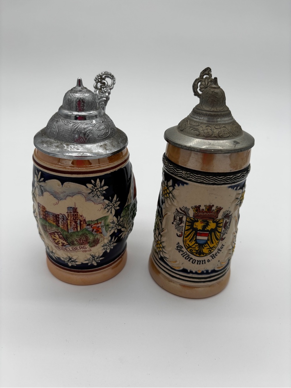 Pair of Vintage Decorative German Ceramic Beer Steins with Pewter Lids